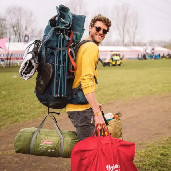 Tom with a lot of backpacks